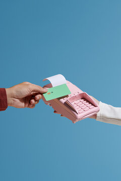 woman's hand holding a pos device and someone stretching a credit