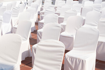 Fototapeta premium Many chairs with white elegant covers 