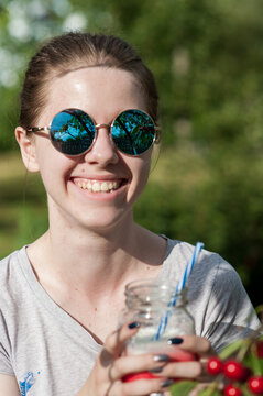 The  young woman in sunglasses