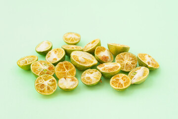 Freeze-dried small limes on a solid color background