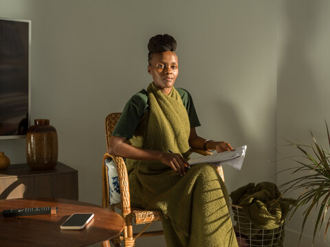 Black female student sitting on chair learning language