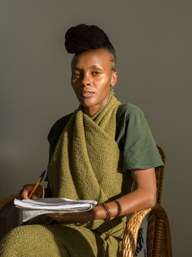 Black woman with notebook in living room