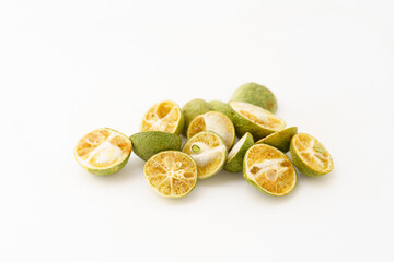 Freeze-dried small limes on a solid color background