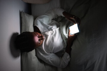 Woman addicted to gadgets using cellphone at night