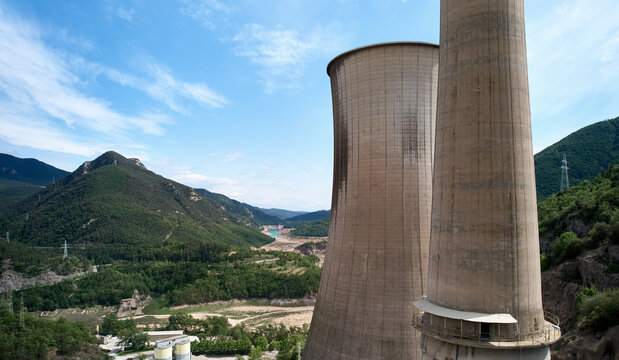 Disused coal power plant tower and empty hydro electric dam