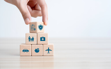 insurance concept. Hand-arranging wood blocks with insurance icons for life, family, financial, and health insurance. accident insurance for car or travel.