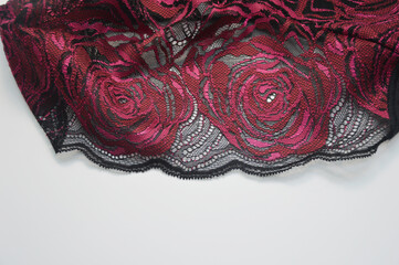 Black lace with bright pink roses. Decorative element for decorating sexy underwear.