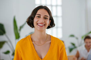 Female pregnant worker portrait in the office