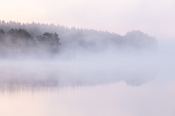 Dawn over a fog covered lake