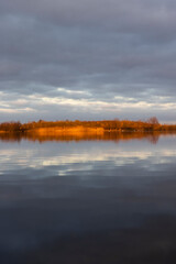 Fototapeta premium a large lake in winter in the morning during sunrise