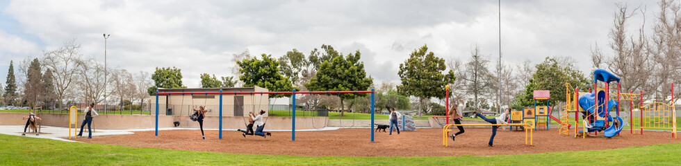 Long Panorama of Two People in Multiple Places on Playground Equipment at City Park, California, USA