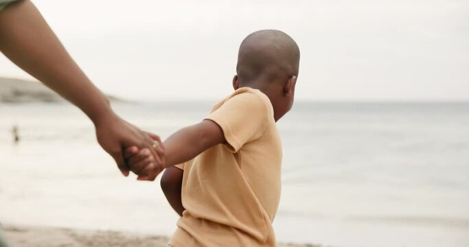 Parent, child and holding hands on beach for support, bonding and holiday by ocean waves. Family and african kid walking to sea or coast with help and guide on vacation, travel and playing game