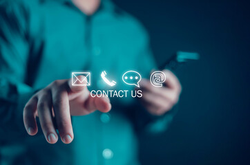 Businessman using virtual screen contact icons Contact us or connect customer support hotline....