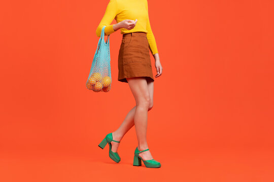 Hands and arms of stylish young woman dressed brown jeans skirt
