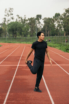 Young man performing stretching exercise.