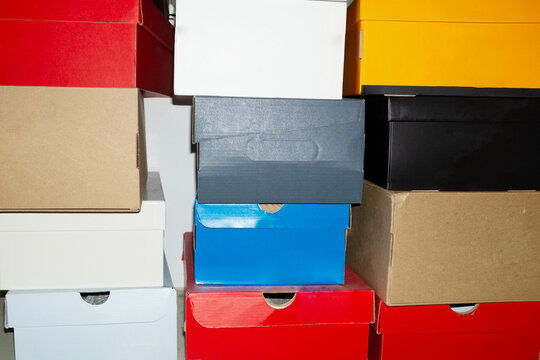 Colourful shoe boxes in towers / stacks with hard direct flashlight
