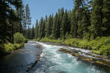 Cyan water flowing over flat rocks