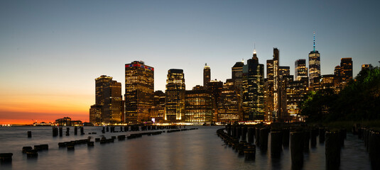 Twilight tones frame the silhouette of a New York City skyline, capturing the transition from...