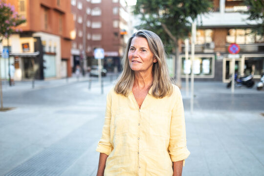 mature woman walking through the streets of a nice city
