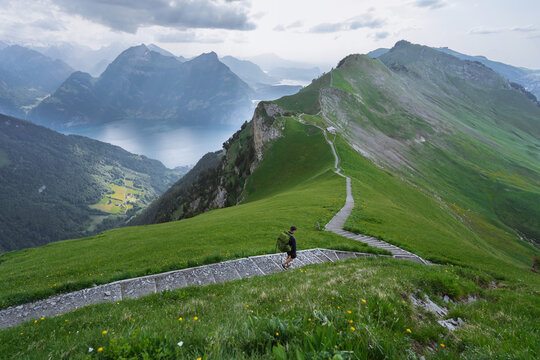 Man Hiking On Scenic Trail In Swiss Alps