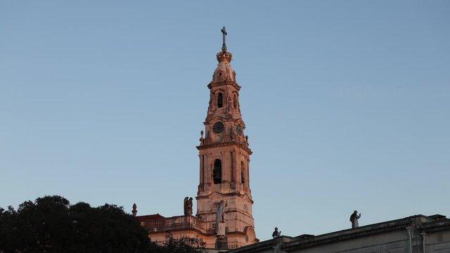 4K sunset video with Fatima Sanctuary in Portugal. Basilica of Our Lady of the Rosary filmed against rose blue sky before night. Religious travel to Portugal.
