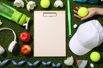 Notepad with sports accessories and spring flowers.