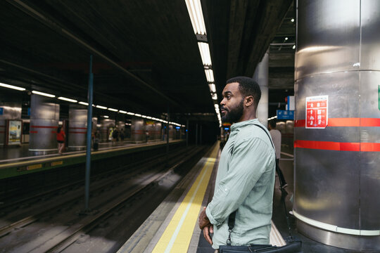 Man Waiting For The Train Standing On The Subway Platform