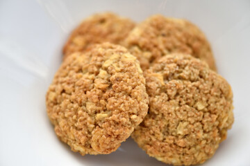 Oatmeal cookies on a white plate. Healthy food for breakfast or a snack. Close up. Soft focus