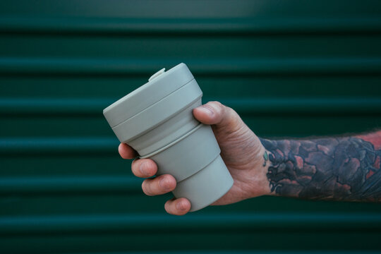 Reusable coffee cup in hand
