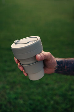 Reusable coffee cup in hand