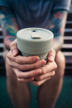 Reusable coffee cup in hands