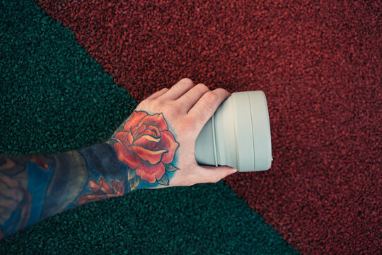 Reusable coffee cup in hand