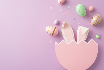 Easter joy creatively captured from top view, including eggs in every shade, bunny ears from a broken egg, and confetti on a lilac background, with space for wording