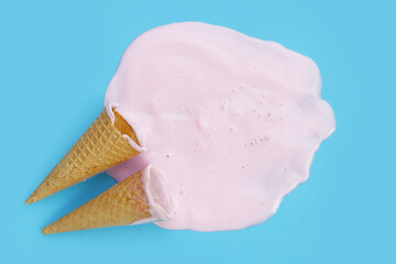 Melting ice cream on blue background.