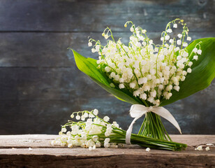 lily of the valley bouquet in spring seasonal may from white flowers on table wooden