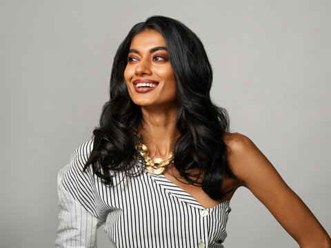 Happy, Confident Woman Wearing Fancy Outfit And Gold Accessories