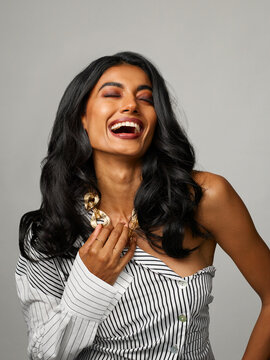 Elegant, fancy woman laughing, having fun studio portrait
