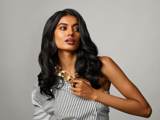 Chic, stylish model studio portrait with grey background