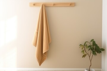 Terry white towel template on a wooden hanger, hanging towelling for design, branding, presentation. Home decor for wiping after a shower. Towelette mockup isolated on background. Product photography.