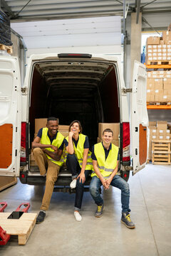 Warehouse Workers Sitting At Open Delivery Van