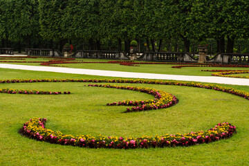 Blooming flowers in Mirabell Gardens in Salzburg in the early summer sunny day