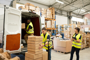 Group Of People Loading Delivery Van At Warehouse