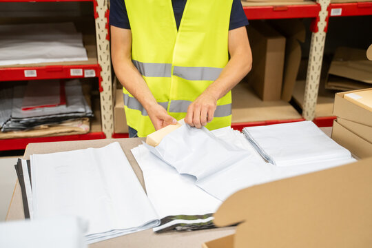 Anonymous Worker Packing Parcel Indoors