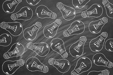 Set of light bulbs chalk drawing on blackboard.