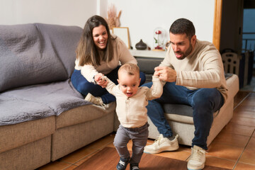 family time, a happy couple enjoys their toddler's first steps in the living room