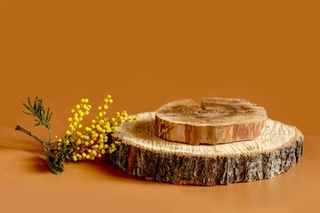 Wooden podium for demonstrating a product, cosmetic product on a brown background with space for...