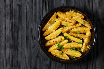 greek lemon potatoes with garlic, cheese on dish