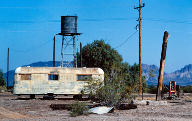 Caravan and water reservoir tabk in the desert of Arizona USA in the eighties.