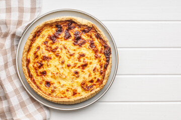 Traditional french pie. Quiche lorraine on white table.