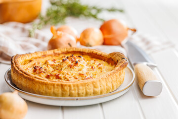 Traditional french pie. Quiche lorraine on white table.